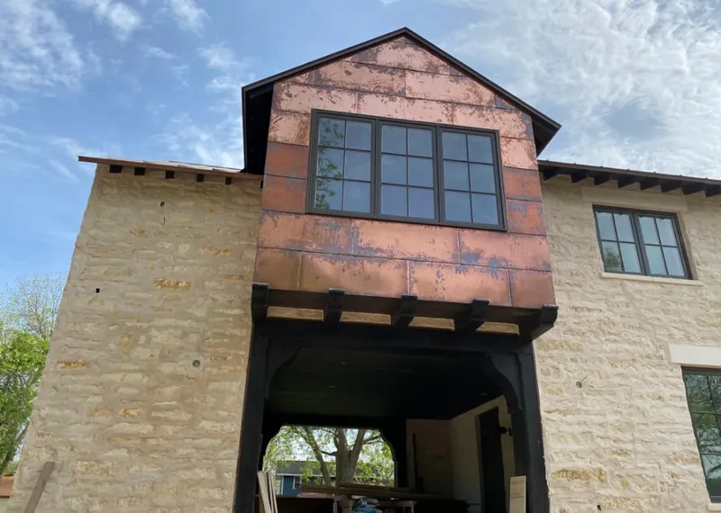 Copper metal panel facade on a stone building for Skylight Installation in Green River